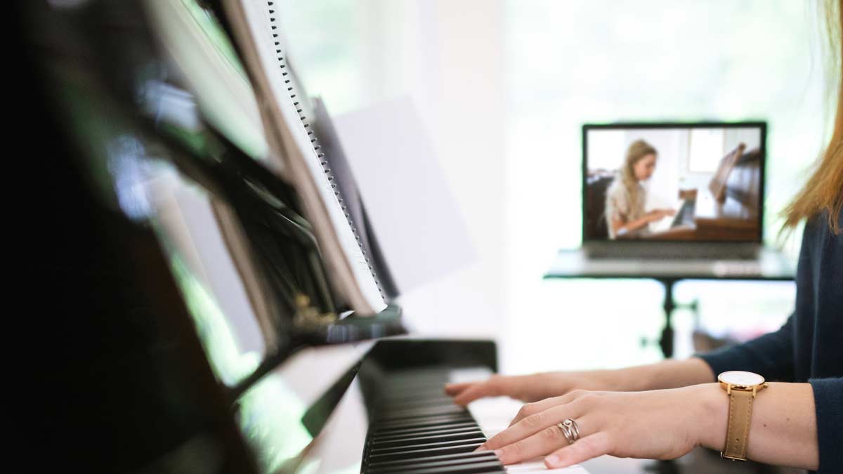 Piano Teacher Instructs Student Via Teleconferencing
